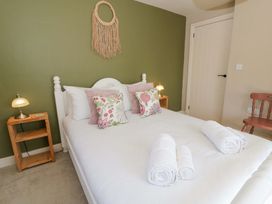 A bedroom with a bed and nightstands at La Bastille in Maenclochog