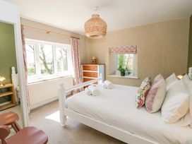 A bedroom with a bed and wooden furniture at La Bastille in Maenclochog