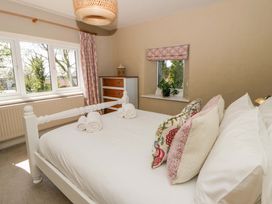 A bedroom with a bed and dresser at La Bastille in Maenclochog