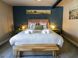A bedroom with a bed and bedside table at La Bastille in Maenclochog