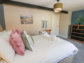A bedroom with a bed and pillows at La Bastille in Maenclochog