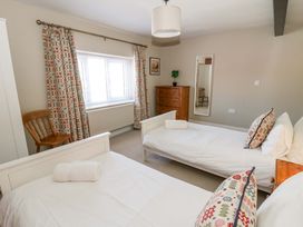 A bedroom with two beds and a dresser at La Bastille in Maenclochog