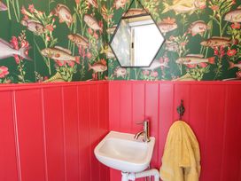 A bathroom with a sink and yellow towel at La Bastille in Maenclochog