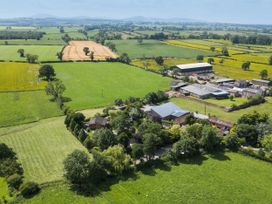 An aerial view of fields and buildings at Cedrus Lodge in Skelton near Penrith