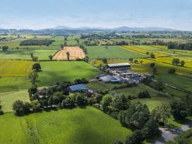 A farm with fields and a barn at Cedrus Lodge Skelton near Penrith