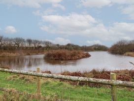 A body of water with an island covered in vegetation and trees in the background near Hartland