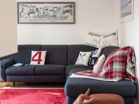 A living room with a sofa and cushions at Pentire St Minver