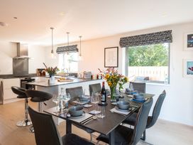 A kitchen with a dining table set for a meal at Pentire in St Minver