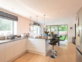 A kitchen with a countertop and dining area at Pentire in St Minver