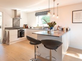 A kitchen with modern appliances and seating at Pentire St Minver