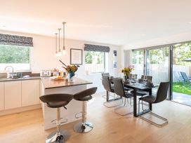 A kitchen with dining area and sliding doors at Pentire in St Minver