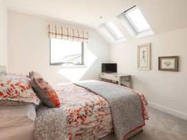 A bedroom with a bed and television at Pentire in St Minver