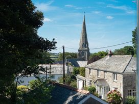 A view of a church steeple and houses at Pentire St Minver