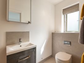 A bathroom with sink and mirror at Pentire in St Minver