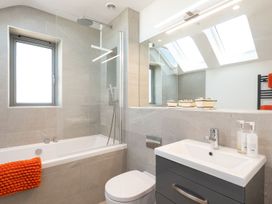 A bathroom with a bathtub and sink at Pentire St Minver