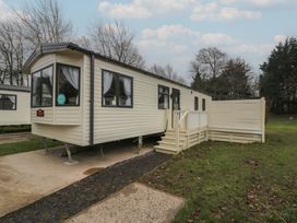 A static caravan with steps and decking at Woodlands Gold (WO 41) in Ruthin