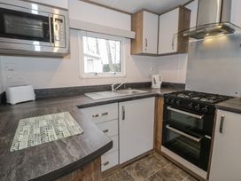 A kitchen with appliances and countertop at Woodlands Gold (WO 41) in Ruthin