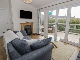 A living room with a sofa and coffee table at Platinum Lodge (503) Talybont