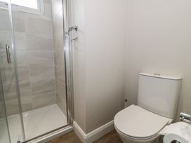 A bathroom with a shower and a toilet at Platinum Lodge (503) Talybont