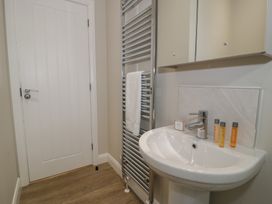 A bathroom with a sink and a towel rail at Platinum Lodge (503) Talybont