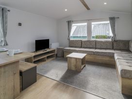 A living room with a sofa and coffee table at Lido Silver Plus 111 Prestatyn