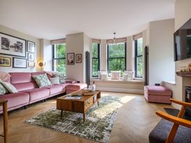 A living room with a pink sofa and coffee table at Riverside in Ambleside