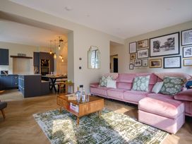 A living room with a pink sofa and coffee table at Riverside in Ambleside