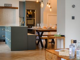 A kitchen with an island and dining table at Riverside in Ambleside