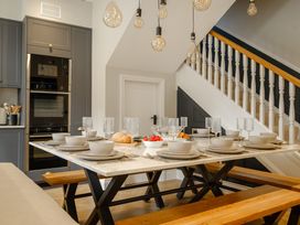 A dining room with a table set for meals at Riverside in Ambleside