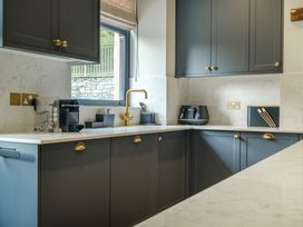 A kitchen with cabinets and appliances at Riverside in Ambleside