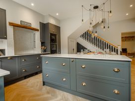 A kitchen with cabinets and a marble countertop at Riverside in Ambleside
