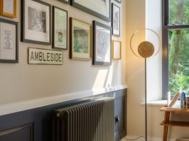 A sitting area with framed pictures and a lamp at Riverside in Ambleside