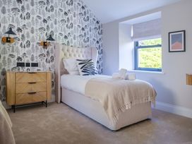 A bedroom with a bed and nightstand at Riverside in Ambleside