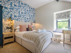 A bedroom with a bed and nightstand at Riverside in Ambleside