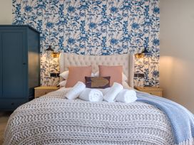 A bedroom with a bed and wardrobe at Riverside in Ambleside