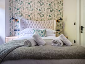 A bedroom with a bed and nightstand at Riverside in Ambleside