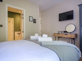 A bedroom with a bed and television at Riverside in Ambleside