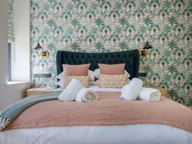 A bedroom with a bed and wallpaper at Riverside in Ambleside