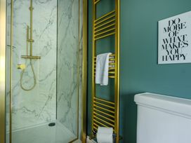 A bathroom with a shower and a towel rack at Riverside in Ambleside