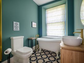 A bathroom with a bathtub sink and toilet at Riverside in Ambleside