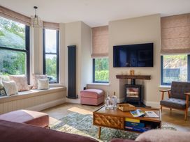 A living room with a sofa and television at Riverside in Ambleside