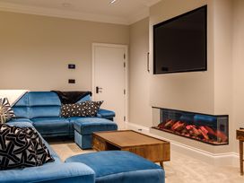 A living room with a sofa and television at Riverside in Ambleside