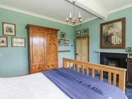 A bedroom with a bed and wardrobe at Plas Pontfaen near Fishguard and Newport, Pembrokeshire