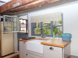A kitchen with a sink and refrigerator at 1 Myrtle Cottages Stokeinteignhead