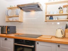 A kitchen with a microwave, hob, and kettle at 1 Myrtle Cottages in Stokeinteignhead
