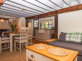 A kitchen with dining area and wooden features at 1 Myrtle Cottages Stokeinteignhead