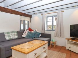 A living room with a sofa and coffee table at 1 Myrtle Cottages Stokeinteignhead