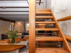 A room with a staircase and dining area at 1 Myrtle Cottages Stokeinteignhead