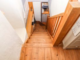 A staircase with wooden steps leading down at 1 Myrtle Cottages in Stokeinteignhead