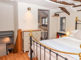 A bedroom with a bed and nightstand at 1 Myrtle Cottages Stokeinteignhead